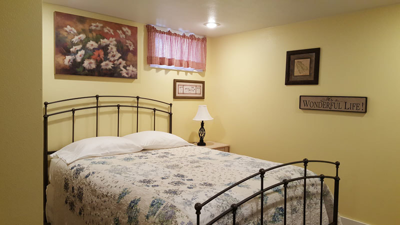 Lower level bedroom with queen bed